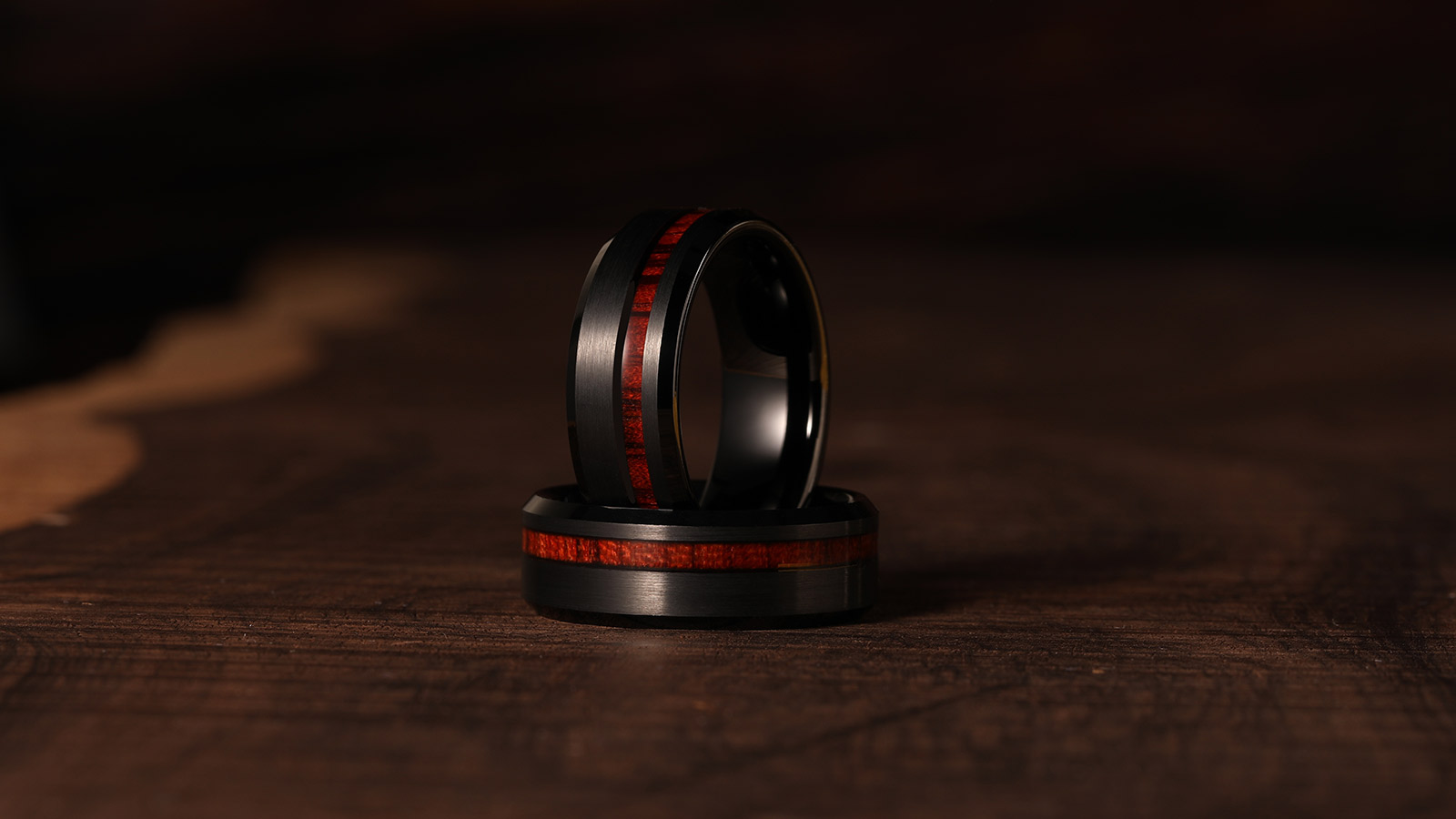 Black ring with a wooden inlay in the center was placed on a wooden board