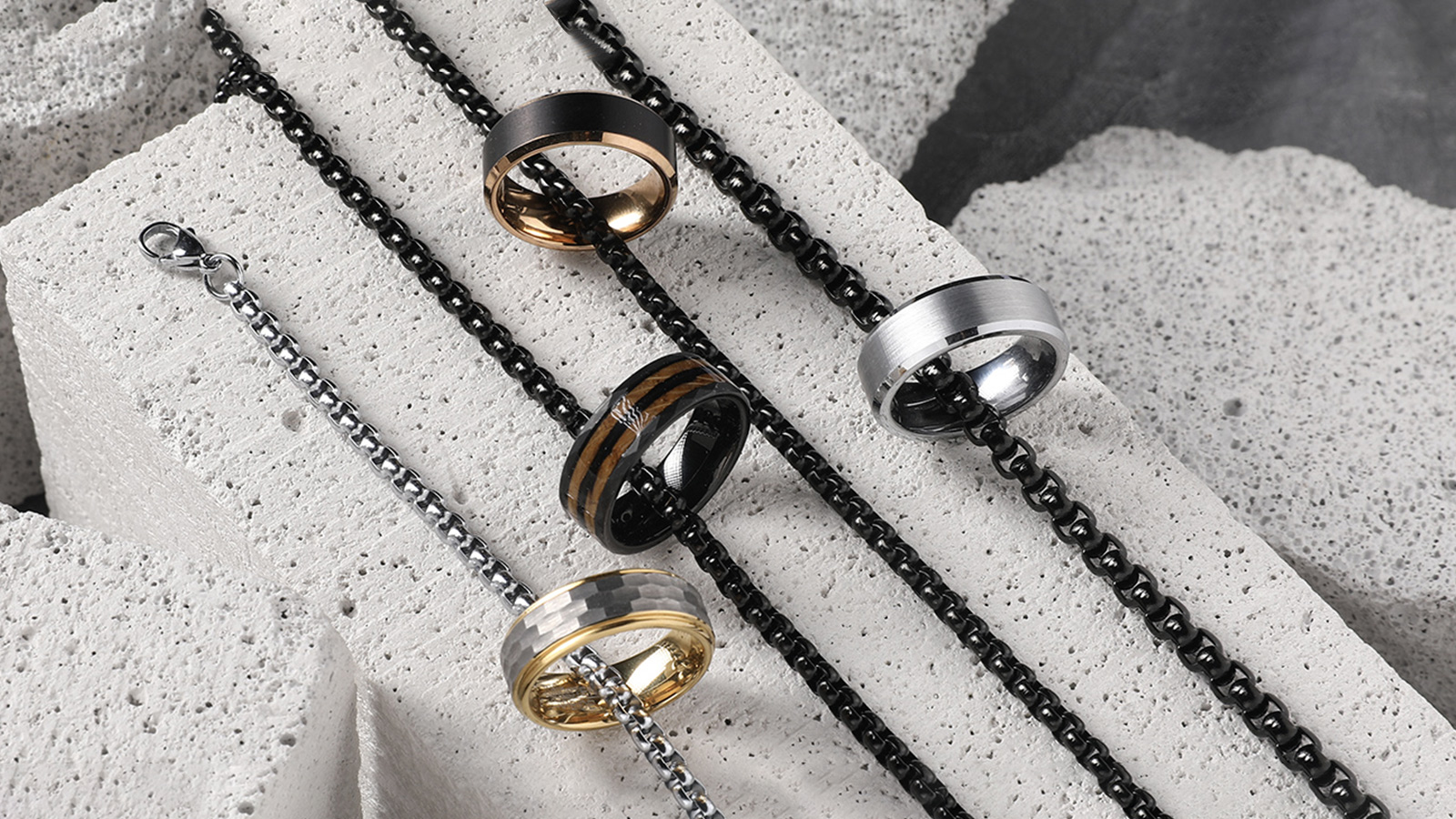 Four different styles of men's rings and necklaces