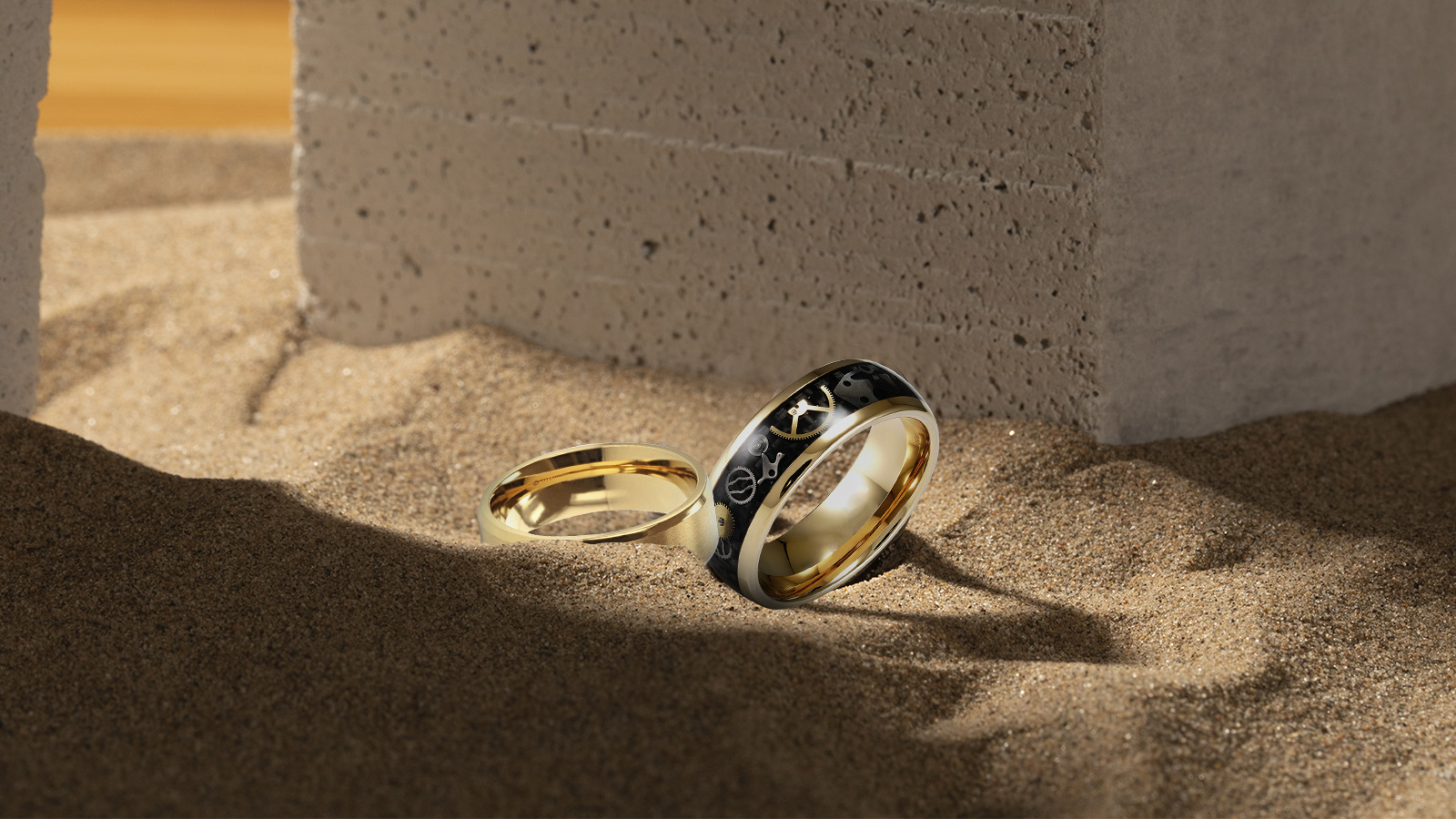 yellow gold wedding bands on the sand