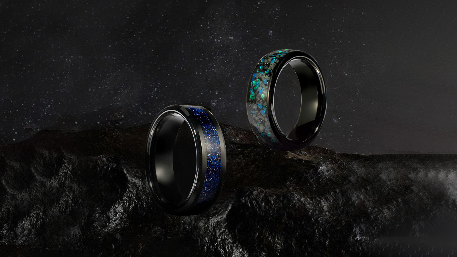 Two black men's wedding rings, with multi-color inlays in the middle, look fashionable