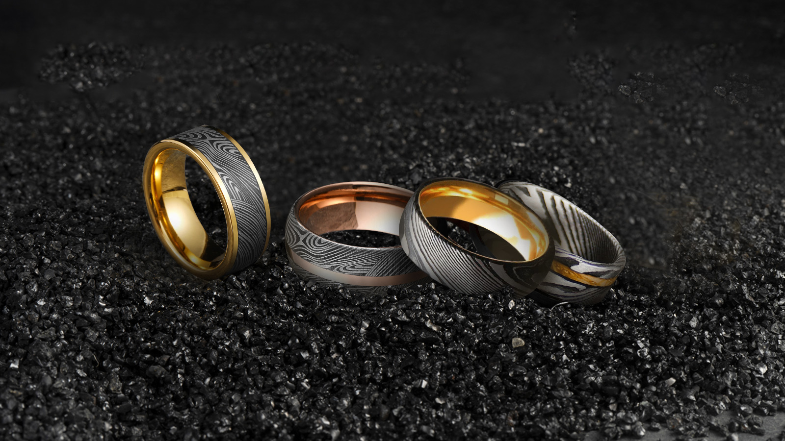 Four elegant Damascus steel rings made of different metals